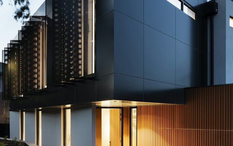 Contemporary house facade with timber and dark cladding